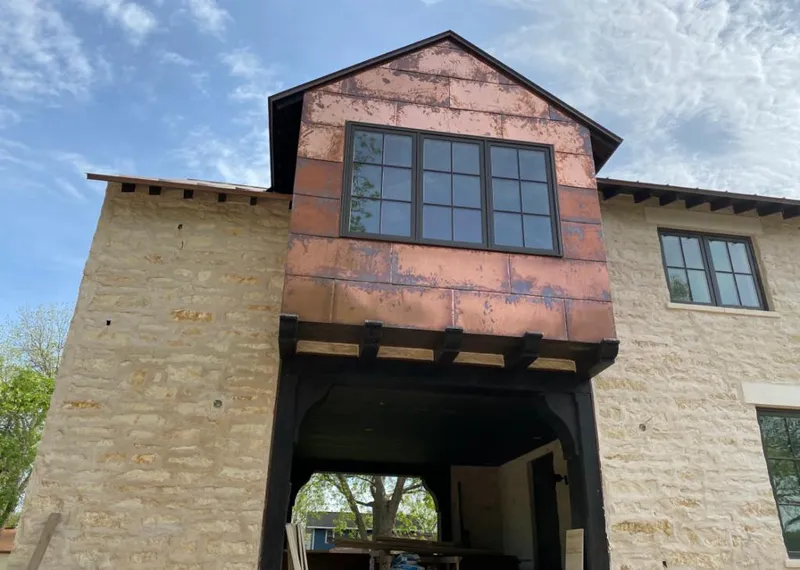 Copper metal panel facade on a stone building for Roof Repair in Deer Park